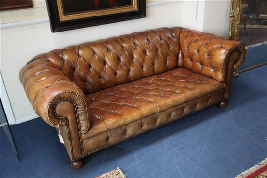 A brown leather buttoned Chesterfield settee, W.6ft 6in.